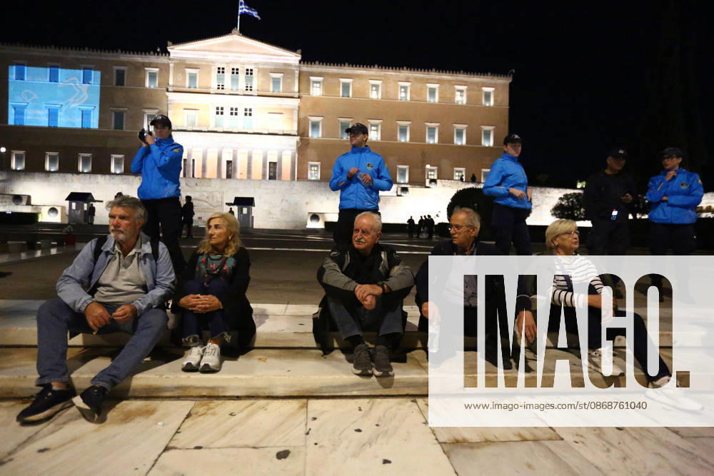 Demonstrators sit on steps in front of the Greek Parliament on Syntagma Square, as police officers stand behind them during an anti-war protest opposing the visit of US Secretary of State MARCO RUBIO. Athens GREECE - ZUMAx103 20261006_zip_x103_012