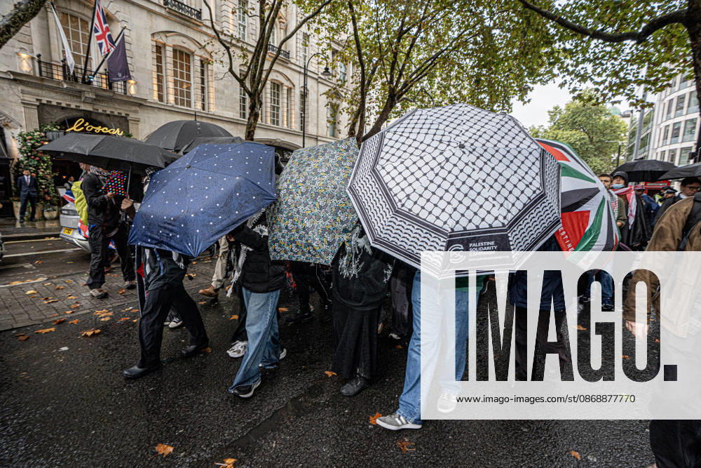 Pro-Israeil counter protestors challenge pro-Palestine demonstrators in London, UK - 7 OCT 2026. Pro-Palestine activists from London universities seen shielding themselves behind a protective wall of umbrellas on their march through central London. Pro-Palestine activists from Central London Universities chose the 3rd anniversary of the October 7th attack by Hamas to protest against Israel’s war on Gaza. They clashed en route with pro-Israeli counter protestors. The demonstration was arranged by an inter-uni coalition that includes King’s College and LSE. London United Kingdom