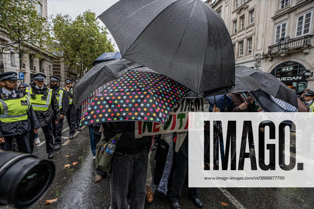 Pro-Israeil counter protestors challenge pro-Palestine demonstrators in London, UK - 7 OCT 2026. Pro-Palestine activists from London universities seen shielding themselves behind a protective wall of umbrellas on their march through central London. Pro-Palestine activists from Central London Universities chose the 3rd anniversary of the October 7th attack by Hamas to protest against Israel’s war on Gaza. They clashed en route with pro-Israeli counter protestors. The demonstration was arranged by an inter-uni coalition that includes King’s College and LSE. London United Kingdom
