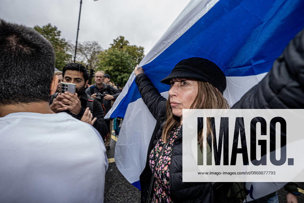 Pro-Israeil counter protestors challenge pro-Palestine demonstrators in London, UK - 7 OCT 2026. A woman seen holding a large flag during the 3rd anniversary of the October 7th attack by Hamas to protest against Israel’s war on Gaza. Pro-Palestine activists from Central London Universities chose the 3rd anniversary of the October 7th attack by Hamas to protest against Israel’s war on Gaza. They clashed en route with pro-Israeli counter protestors. The demonstration was arranged by an inter-uni coalition that includes King’s College and LSE. London United Kingdom
