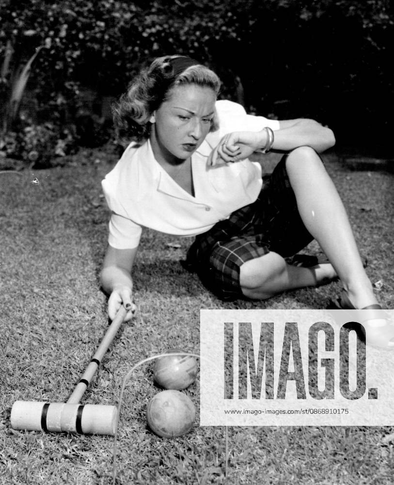 Lawn Golfer -- Actress Bonita Granville is having a wicket time determining her next move in a croquet match. Anyway, she looks good in her Plaid Peddle-pushers and White Blouse. October 8, 1947. (Photo by Wide World Photos).