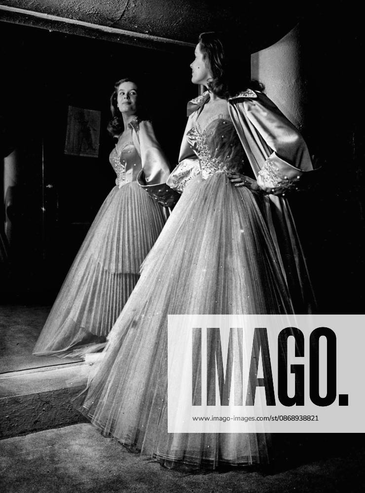 Every Girl will envy Sally Ann Howes, Posing here in a pleated tulle crinoline in rainbow colouring. There are 120 yards of tulle in the creation which Sally will wear in the new play Caprice which opens at the Alhambra, Glasgow, next week. With it, she is wearing an oyster pink satin coat embroidered with mother of pearl. October 19, 1950.