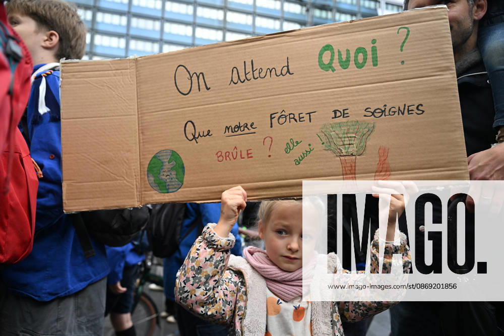 Tens of thousands march in Brussels demanding stronger climate action BRUSSELS, BELGIUM - OCTOBER 11: Demonstrators hold climate-themed placards as tens of thousands of people march through Brussels calling for stronger action against climate change and reduced dependence on fossil fuels, on October 11, 2026 in Brussels, Belgium. The protest was organized by the Belgian Climate Coalition, which brings together around 100 civil society organizations. Participants marched along major roads toward Schuman Square, home to several European Union institutions, while protesting the government s climate policies. Dursun Aydemir Anadolu Brussels Belgium. Editorial use only. Please get in touch for any other usage.