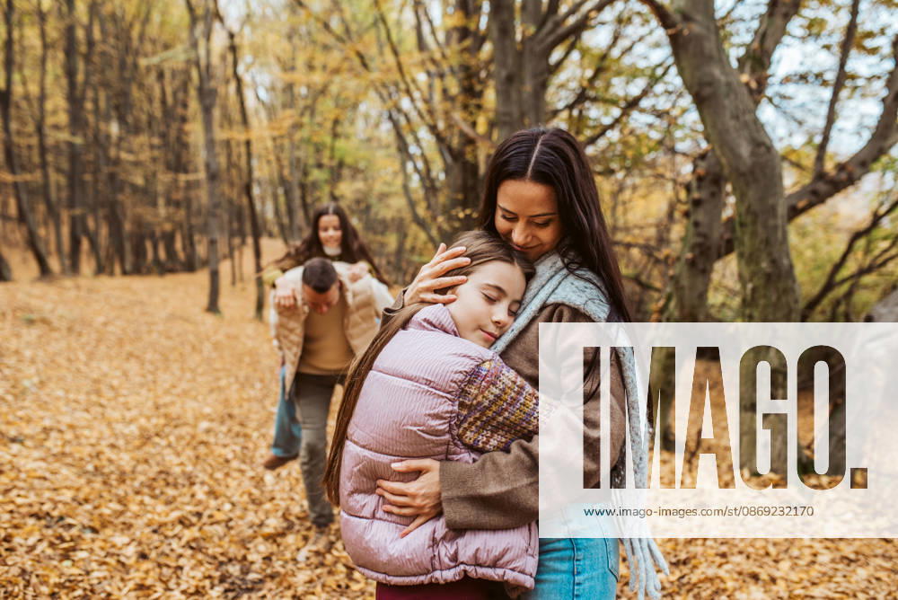 Family portrait of parents with two daughter, in the middle of autumn forest. Family portrait of parents with two daughter, standing in autumn nature. model released