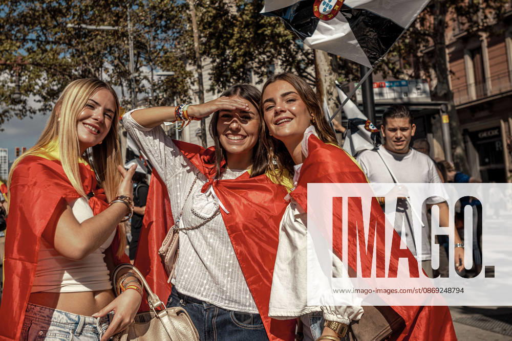 Three women wrapped in Spanish flags pose beneath a flag of Ceuta during a demonstration marking SpainÃ¢â‚¬â ¢s National Day. Barcelona Spain - ZUMAo105 20261012_fap_o105_002