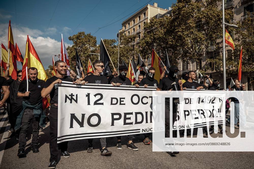 Demonstrators march behind a banner reading October 12, 1492: We do not ask for forgiveness. during a rally marking Spainâ€⠢s National Day Barcelona Spain - ZUMAo105 20261012_fap_o105_008