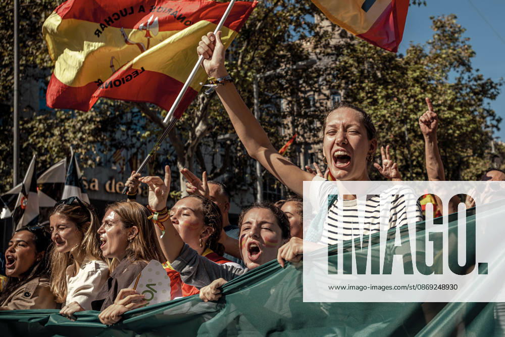 Demonstrators chant slogans behind a banner during a rally marking Spainâ€⠢s National Day. Barcelona Spain - ZUMAo105 20261012_fap_o105_026