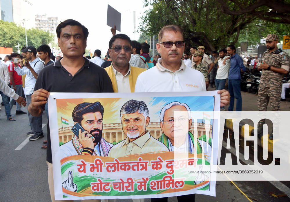 INDIA Bloc protest march towards the Supreme Court in New Delhi New Delhi, Oct 12 (ANI): Three protesters hold a poster in their hands during the INDIA Bloc protest march towards the Supreme Court, in New Delhi on Monday. NEW DELHI Delhi India