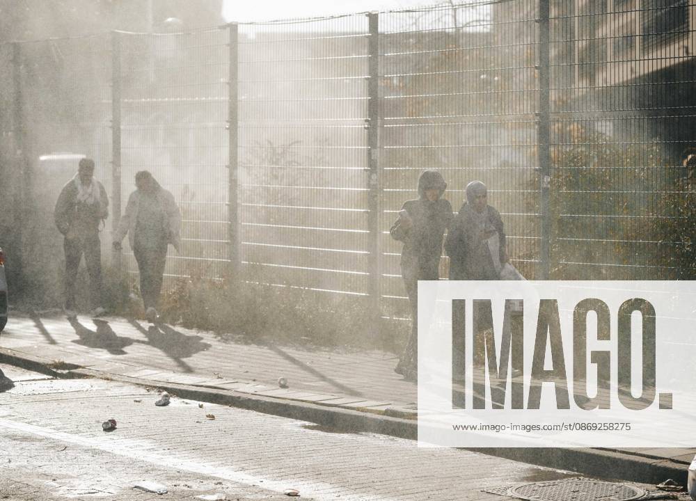 Brussels Belgium Protest People walk past a fenced area amid gas smoke during a protest in Brussels, Belgium on October 12, 2026. Protesters and trade union members stage demonstrations and clash with police during a nationwide public-sector strike against government austerity measures, budget cuts, and reform plans in Brussels, Belgium. Brussels Brussels Capital Belgium