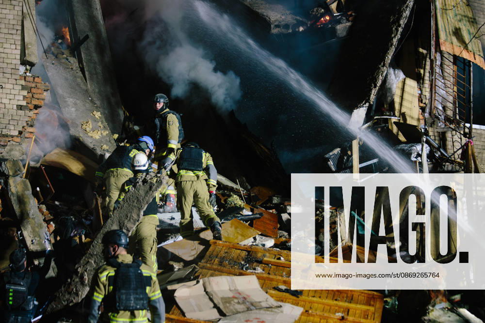 Consequences Of The Attack On Kharkiv Rescuers spray water to extinguish a fire while clearing rubble to reach trapped people in Kharkiv, Ukraine, on October 12, 2026. Kharkiv Ukraine