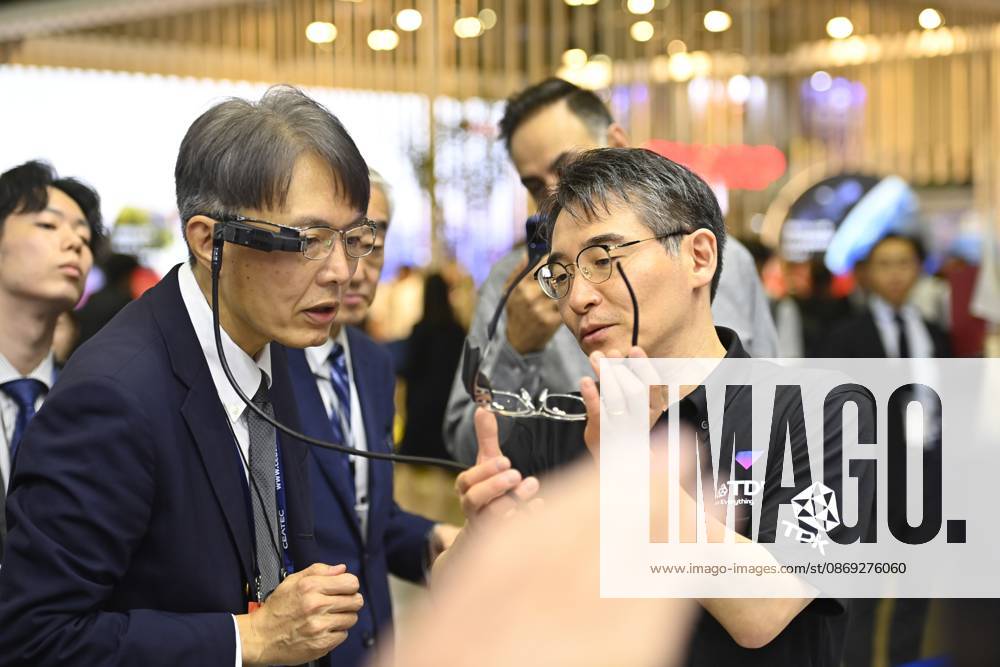 Japan showcases emerging technologies at CEATEC 2026 CHIBA, JAPAN - OCTOBER 13: A visitor tries on a prototype of smart glasses featuring Meta-Optic Mirror technology developed by Japanese electronics company TDK during CEATEC 2026 at Makuhari Messe in Chiba, Japan, October 13, 2026. The prototype uses an ultra-thin optical mirror to direct projected images onto the retina, with TDK aiming to develop more compact and conventional-looking smart glasses. David Mareuil Anadolu Chiba Japan. Editorial use only. Please get in touch for any other usage.