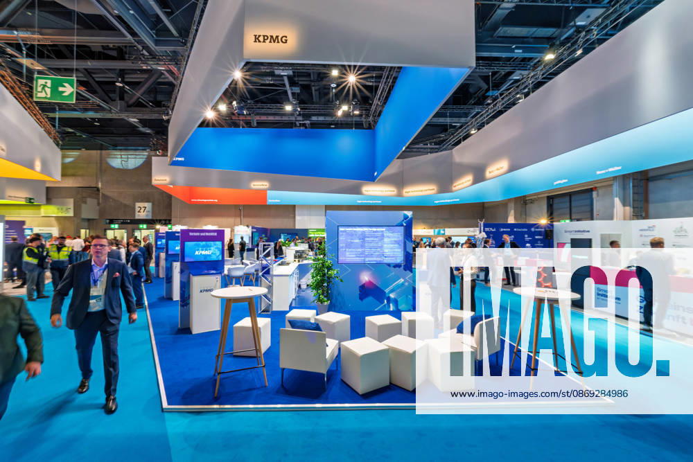 Berlin, 13.10.2026: Der Messestand der Wirtschaftsprüfungs- und Beratungsgesellschaft KPMG unter einem blau beleuchteten Deckenaufbau auf der Smart Country Convention in der Halle hub27. Beratungsunternehmen wie KPMG begleiten Bund, Länder und Kommunen bei der Digitalisierung ihrer Verwaltungsprozesse. Die Smart Country Convention (SCCON) ist die Kongressmesse für die Digitalisierung des öffentlichen Sektors und wird vom Digitalverband Bitkom gemeinsam mit der Messe Berlin veranstaltet. Vom 13. bis 15. Oktober 2026 treffen sich in der Halle hub27 Vertreter aus Bund, Ländern und Kommunen mit Unternehmen der Digitalwirtschaft, um über digitale Verwaltung, Smart City und digitale Souveränität zu diskutieren. KPMG-Stand auf der Smart Co