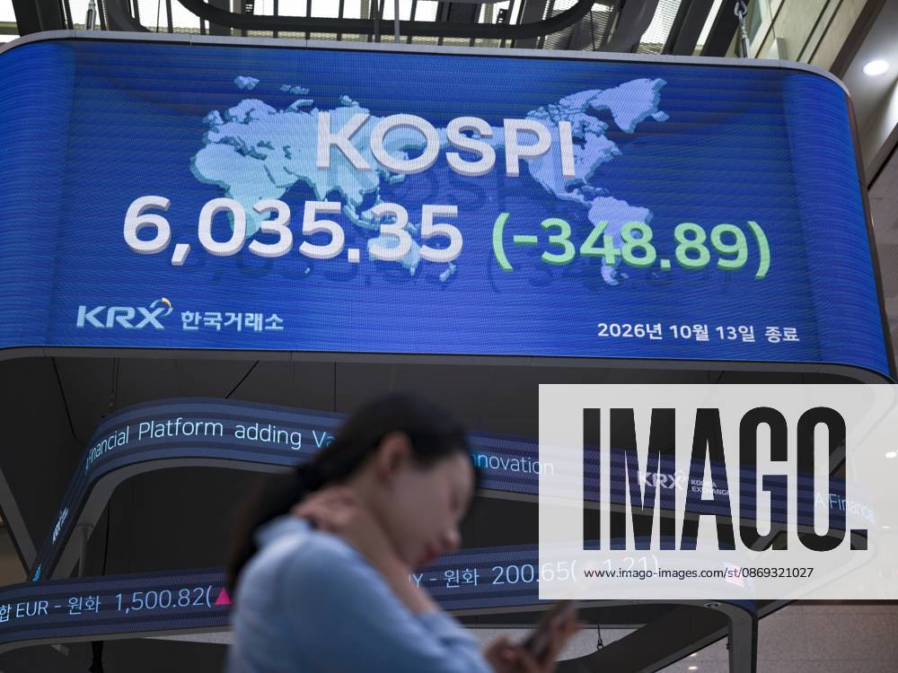 South Korea Stocks Plunge As KOSPI Drops Sharply At KRX In Seoul A Korea Exchange (KRX) employee checks her mobile phone in front of the main display showing the closing KOSPI index at 6,035.35 (-348.89) in Yeouido, Seoul, South Korea, on October 13, 2026. Seoul Seoul South Korea