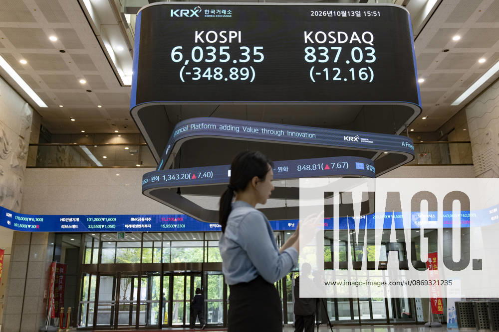 South Korea Stocks Plunge As KOSPI Drops Sharply At KRX In Seoul A Korea Exchange (KRX) employee checks her smartphone near the main electronic board displaying the closing KOSPI index at 6,035.35 (-348.89) and KOSDAQ index at 837.03 (-12.16) in Yeouido, Seoul, South Korea, on October 13, 2026. Seoul Seoul South Korea