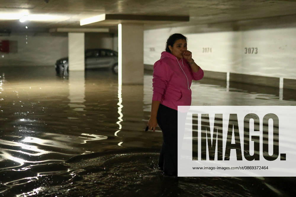 Chile declares a red alert in Santiago following heavy hailstorm SANTIAGO, CHILE - OCTOBER 13: A woman looks at her car stranded in a flooded parking lot following heavy rain and hailstorms in Santiago, Chile, on October 13, 2026. Torrential downpours triggered flash floods across the capital, submerging vehicles and prompting authorities to declare a red alert across the metropolitan area. Lucas Aguayo Araos Anadolu Santiago Chile. Editorial use only. Please get in touch for any other usage.