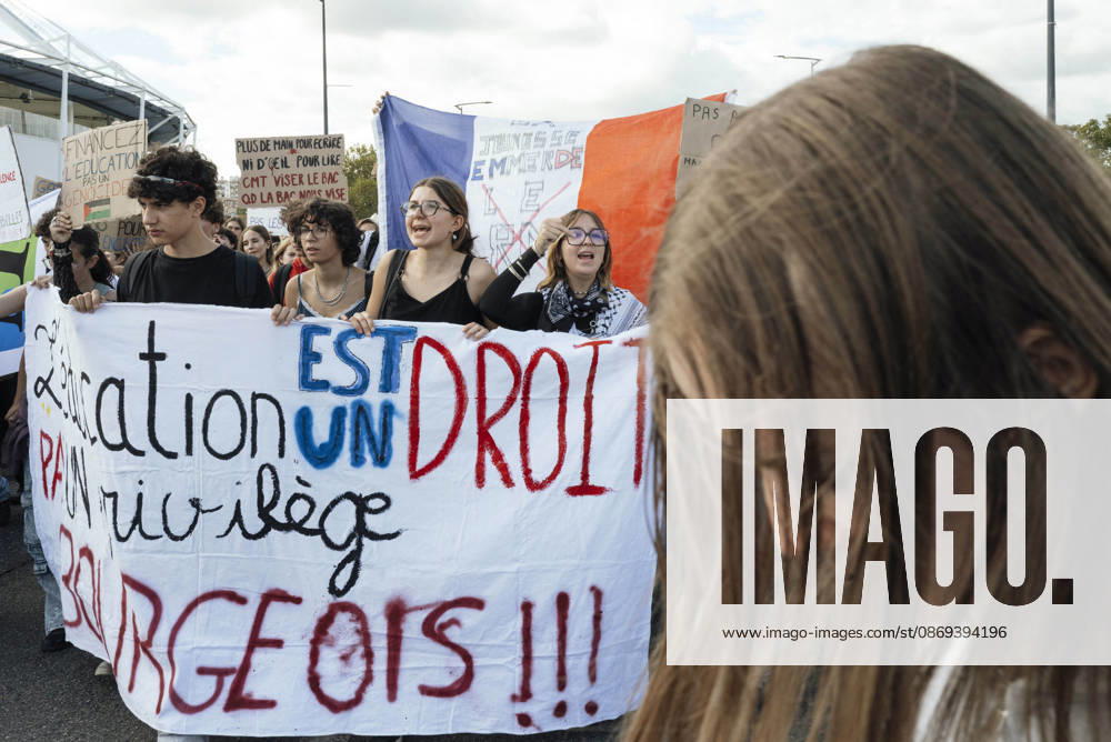 High School Student Mobilisation - Toulouse A blue, white and red flag bearing the slogan - La jeunesse emmerde le RN - in the midst of schoolgirls standing behind a banner. Act V of the secondary school and university students protests. Young people and the world of work are continuing their joint mobilisation and demands for adequate resources for education, better study conditions, an end to student precariousness, and access to housing. France, Toulouse, 13 October 2026. Photo by Patricia Huchot-Boissier AbacaPress.com. TOULOUSE OCCITANIE France