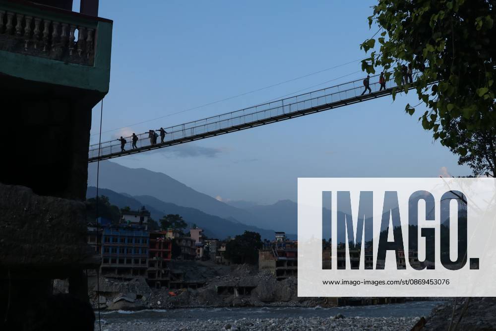 NUWAKOT, NEPAL, OCTOBER 14, 2026: Residents cross a newly built suspension bridge over the Trishuli River in Nuwakot, restoring access between communities affected by flash floods. Flooding destroyed bridges and damaged roads in the district, disrupting travel and access to essential services. Nuwakot Nepal - ZUMAq101 20261014_zna_q101_129