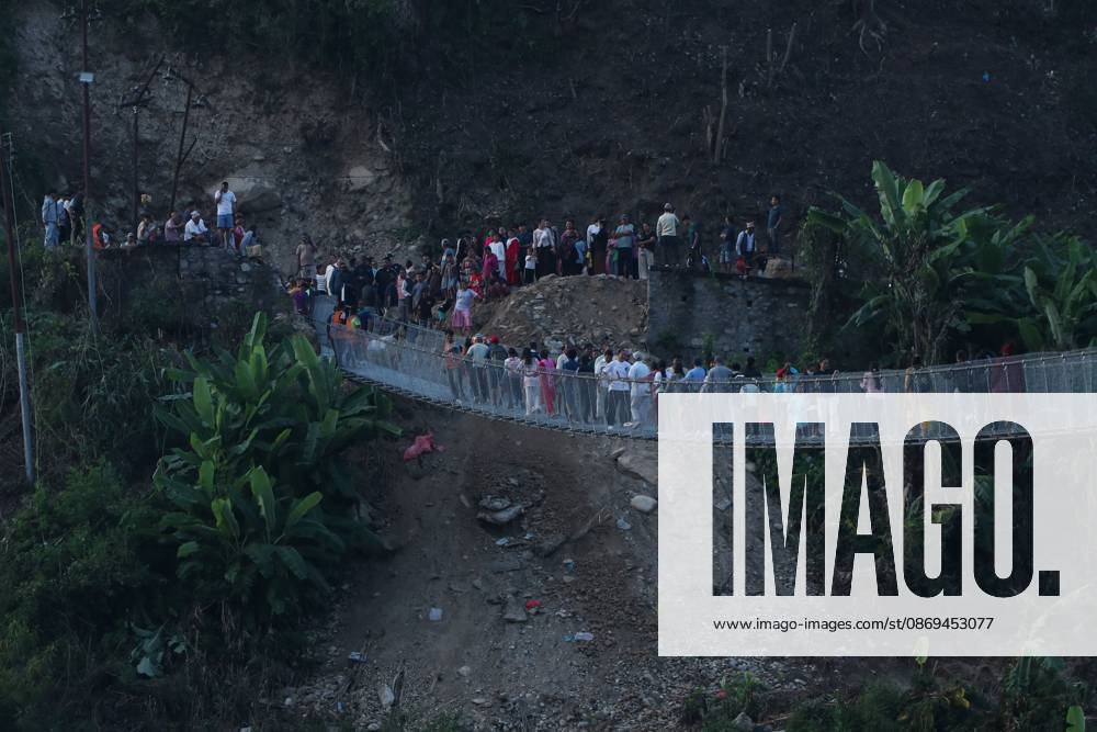 NUWAKOT, NEPAL, OCTOBER 14, 2026: Residents cross a newly built suspension bridge over the Trishuli River in Nuwakot, restoring access between communities affected by flash floods. Flooding destroyed bridges and damaged roads in the district, disrupting travel and access to essential services. Nuwakot Nepal - ZUMAq101 20261014_zna_q101_128