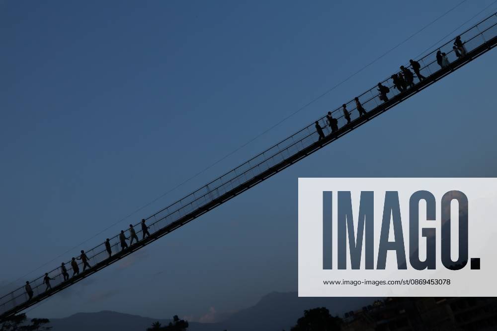 NUWAKOT, NEPAL, OCTOBER 14, 2026: Residents cross a newly built suspension bridge over the Trishuli River in Nuwakot, restoring access between communities affected by flash floods. Flooding destroyed bridges and damaged roads in the district, disrupting travel and access to essential services. Nuwakot Nepal - ZUMAq101 20261014_zna_q101_130
