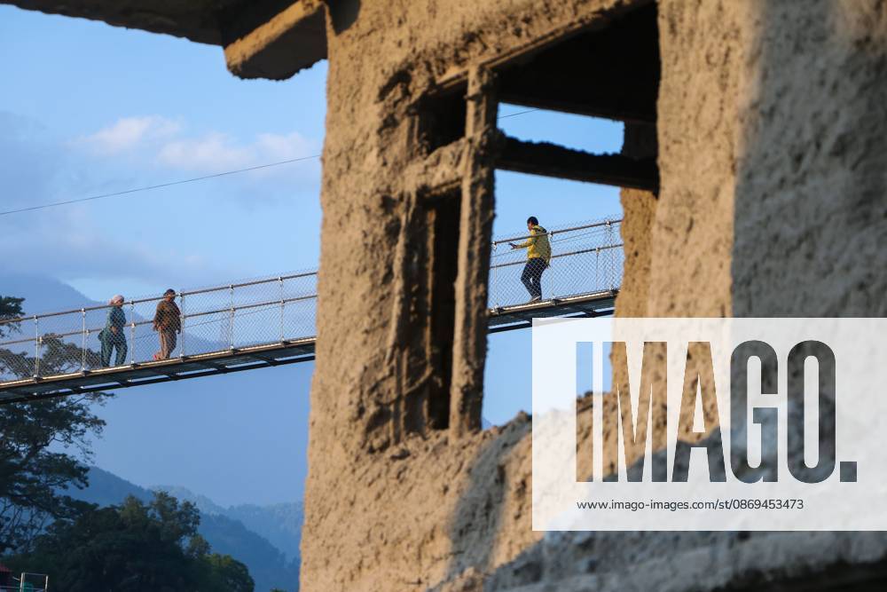 NUWAKOT, NEPAL, OCTOBER 14, 2026: Residents cross a newly built suspension bridge over the Trishuli River in Nuwakot, restoring access between communities affected by flash floods. Flooding destroyed bridges and damaged roads in the district, disrupting travel and access to essential services. Nuwakot Nepal - ZUMAq101 20261014_zna_q101_132