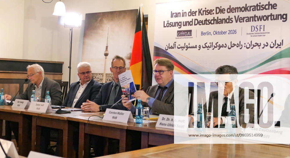 German Bundestag Member, Carsten Müller seen presenting the publication Iran – Innerer Widerstand als strategischer Faktor at the conference table flanked by fellow parliamentarians Detlef Seif, Axel Knoerig, Dr. Hans-Ulrich Seidt and Martin Patzelt. The conference, titled Iran in Crisis: The Democratic Solution and Germany s Responsibility, was organized by the German Solidarity Committee for a Free Iran (DSFI) and the Association of German-Iranians (GDI) at Hopfingerbräu am Brandenburger Tor in Berlin, Germany, on October 14, 2026. The conference brought together German federal lawmakers, former diplomats, and witnesses to discuss human rights, democratic prospects for Iran, and an open letter si - ZUMAs197 20261014_aaa_s197_459