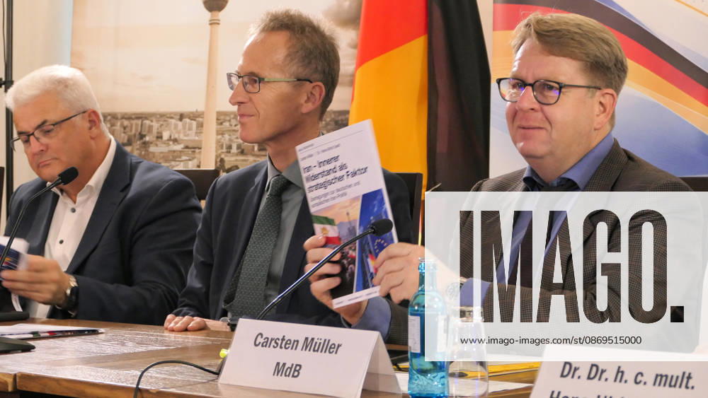 German Member of the Bundestag, Carsten Müller seen holding up the policy paper booklet titled Iran Innerer Widerstand als strategischer Faktor while seated by MPs ,Axel Knoerig and Detlef Seif. The conference, titled Iran in Crisis: The Democratic Solution and Germany s Responsibility, was organized by the German Solidarity Committee for a Free Iran (DSFI) and the Association of German-Iranians (GDI) at Hopfingerbräu am Brandenburger Tor in Berlin, Germany, on October 14, 2026. The conference brought together German federal lawmakers, former diplomats, and witnesses to discuss human rights, democratic prospects for Iran, and an open letter signed by 80 German dignitaries protesting the Fried - ZUMAs197 20261014_aaa_s197_460