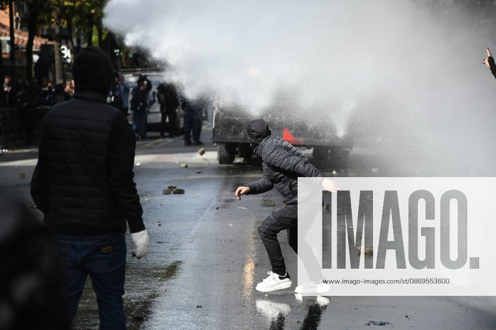 Student protests demanding improved educational conditions continue in Albania TIRANA, ALBANIA - OCTOBER 15: A masked protester crouches as a police water cannon sprays water toward demonstrators during the third day of protests demanding improved educational conditions in Tirana, Albania, on October 15, 2026. University students are joined by high school students and local residents as tensions escalate, with police using tear gas to disperse demonstrators outside the Ministry of Education and the Parliament building, while protesters throw stones and other objects at police officers. Olsi Shehu Anadolu Tirana Albania. Editorial use only. Please get in touch for any other usage.