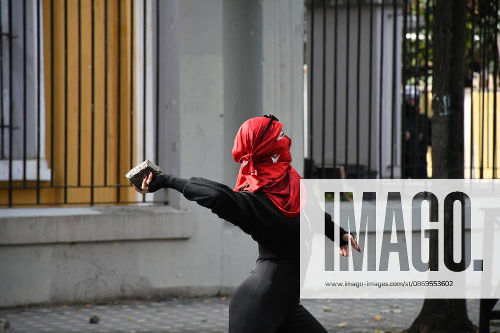 Student protests demanding improved educational conditions continue in Albania TIRANA, ALBANIA - OCTOBER 15: A masked protester prepares to throw a stone during clashes with police on the third day of demonstrations demanding improved educational conditions in Tirana, Albania, on October 15, 2026. University students are joined by high school students and local residents as tensions escalate, with police using tear gas to disperse demonstrators outside the Ministry of Education and the Parliament building, while protesters throw stones and other objects at police officers. Olsi Shehu Anadolu Tirana Albania. Editorial use only. Please get in touch for any other usage.