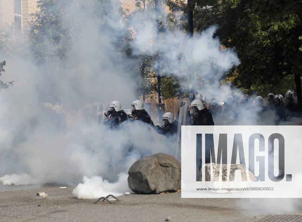 Protesters Clash with Police During a Demonstration in Tirana, Albania. Riot police officers take cover as protester throw back tear gas canisters during an anti-government demonstration in central Tirana on October 15, 2026, as protests continued for a third consecutive day over university conditions and demands for the resignation of Albanian Prime Minister Edi Rama. The latest rally follows two nights of violence in the capital, during which protesters and riot police clashed, police used water cannons and tear gas, and demonstrators damaged government offices and shops and set fire to several buildings. Light Studio Agency Malton Dibra Tirana Albania