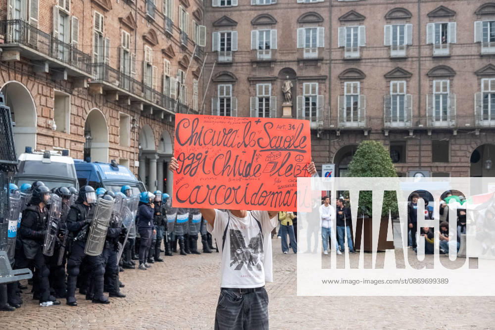 Reportage - Student strike in Turin A protester holding a sign in front of the police during Student strike in Turin, Reportage in Turin, Italy, October 16 2026 Turin City of Turin Italy