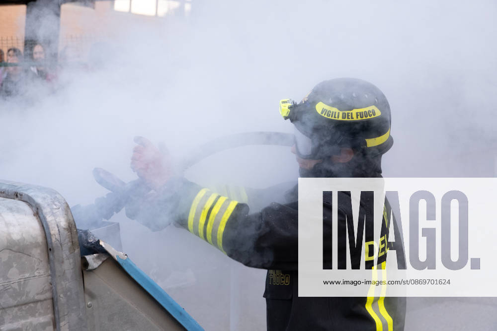 IPA89764837 - Firefighters put out a fire inside a trash can during a student strike. Bologna, Italy