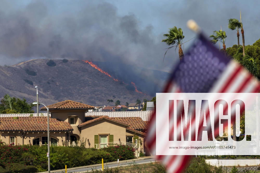 October16, 2026, San Juan Capistrano, California, USA: Fire crews are aggressively battling a wind-driven brush fire that burned several homes and threatened thousands of others in the area of San Juan Capistrano and San Clemente Friday, prompting evacuation orders. The Norte Fire exploded to 465 acres and remains 0 percent contained as of 4 p.m. O.C. Fire Authority officials said the Norte Fire started around 11:30 a.m. near Portico Del Norte and Eminencia Del Norte in San Clemente, east of Interstate 5. Fueled by strong Santa Ana winds, the wildfire then blew into neighboring San Juan Capistrano. San Juan Capistrano USA - ZUMAr19_ 20261016_new_r19_150