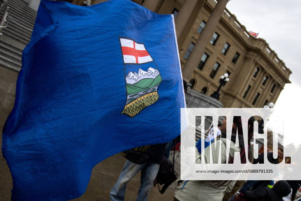 An attendee holds an Alberta flag during an Alberta independence rally at the Alberta legislature, in Edmonton on Saturday, Oct. 17, 2026. Edmonton Canada - ZUMAc35_ 20261017_zaf_c35_042