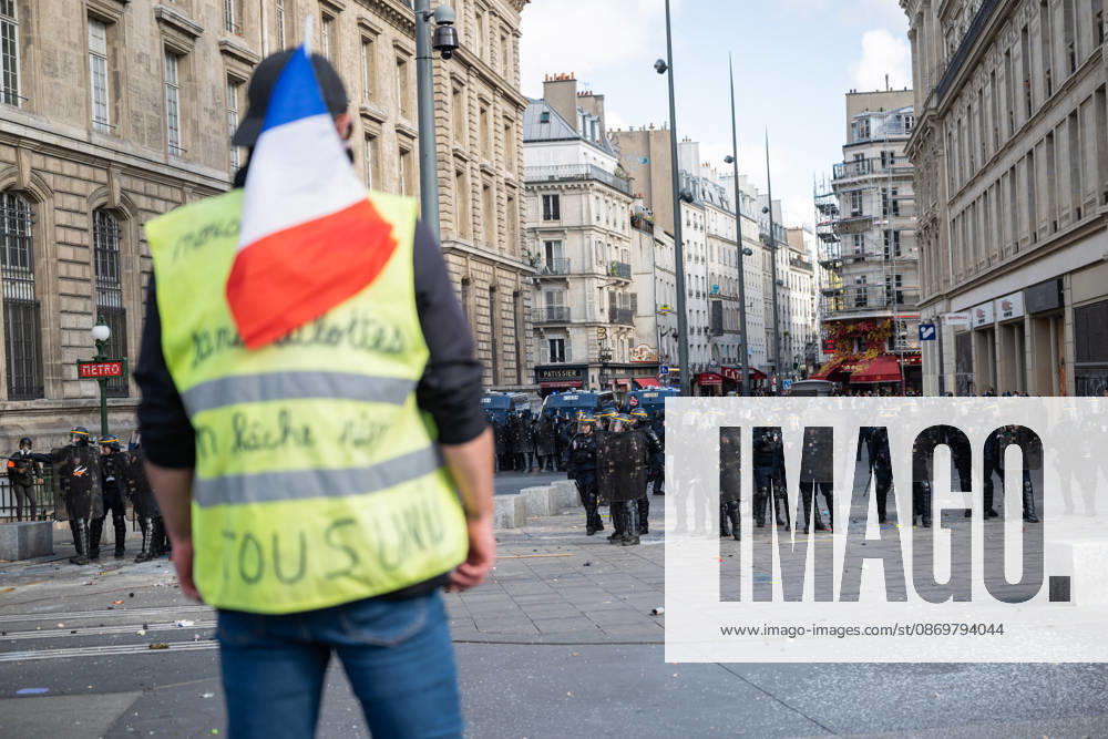 High Cost of Living Protest - Paris AJ A protesters holds a smoke flare and a French national flag during a demonstration to protest against the high cost of living , at Place de la Republique in Paris on October 17, 2026 as part of a nationwide call for mobilisation bringing together various groups expressing their anger: former Yellow Vest , secondary school and university students, climate activists and even farmers. After weeks of student protests, France faces broader, nationwide demonstrations on October 17, 2026 over the cost of living, setting up a potentially fraught six months heading into a presidential election. A police source told AFP that authorities estimated nearly 200,000 people could take part, with 40,000 in Paris. Pho