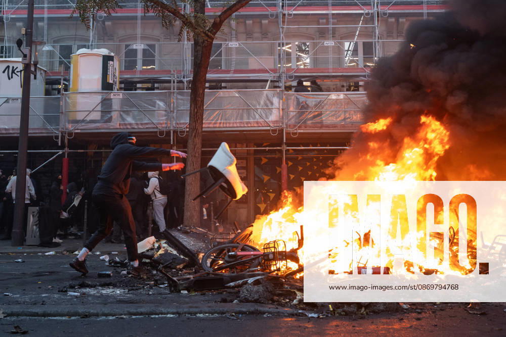 High Cost of Living Protest - Paris AJ Protesters throw an object in the flames during a demonstration to protest against the high cost of living , at Place de la Republique in Paris on October 17, 2026 as part of a nationwide call for mobilisation bringing together various groups expressing their anger: former Yellow Vest , secondary school and university students, climate activists and even farmers. After weeks of student protests, France faces broader, nationwide demonstrations on October 17, 2026 over the cost of living, setting up a potentially fraught six months heading into a presidential election. A police source told AFP that authorities estimated nearly 200,000 people could take part, with 40,000 in Paris. Photo by Alexis Jumeau