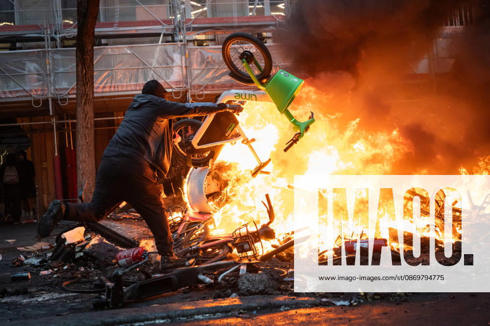 High Cost of Living Protest - Paris AJ Protesters throw an object in the flames during a demonstration to protest against the high cost of living , at Place de la Republique in Paris on October 17, 2026 as part of a nationwide call for mobilisation bringing together various groups expressing their anger: former Yellow Vest , secondary school and university students, climate activists and even farmers. After weeks of student protests, France faces broader, nationwide demonstrations on October 17, 2026 over the cost of living, setting up a potentially fraught six months heading into a presidential election. A police source told AFP that authorities estimated nearly 200,000 people could take part, with 40,000 in Paris. Photo by Alexis Jumeau