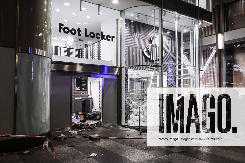 IPA89830536 - Milan: Damage caused by clashes between protesters and police during the Italia in Piazza demonstration against the high cost of living in the city center. Pictured: Damage to the Foot Locker store on Corso Vittorio Emanuele II