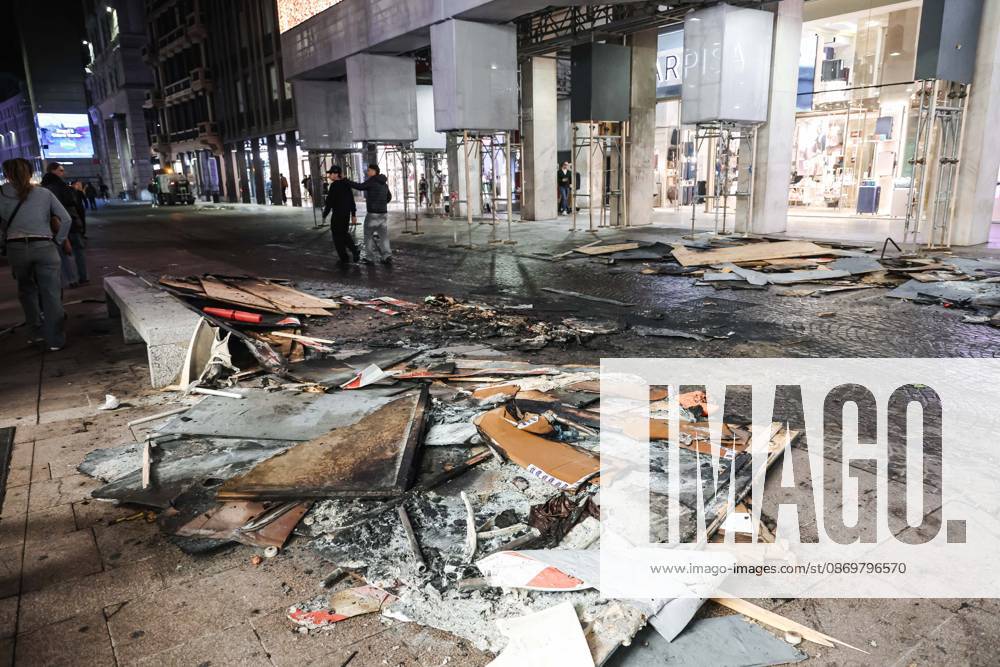 IPA89830545 - Milan: Damage caused by clashes between protesters and police during the Italia in Piazza demonstration against the high cost of living in the city center. Pictured: Damage on Corso Vittorio Emanuele II