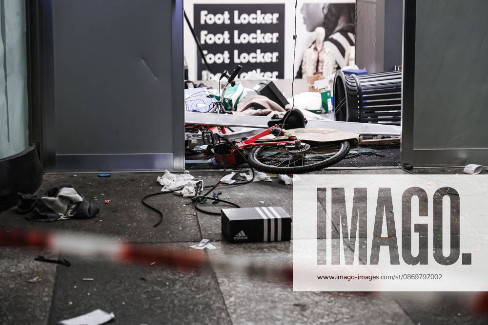 IPA89830537 - Milan: Damage caused by clashes between protesters and police during the Italia in Piazza demonstration against the high cost of living in the city center. Pictured: Damage to the Foot Locker store on Corso Vittorio Emanuele II