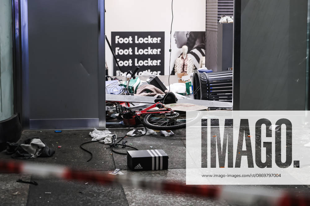 IPA89830538 - Milan: Damage caused by clashes between protesters and police during the Italia in Piazza demonstration against the high cost of living in the city center. Pictured: Damage to the Foot Locker store on Corso Vittorio Emanuele II