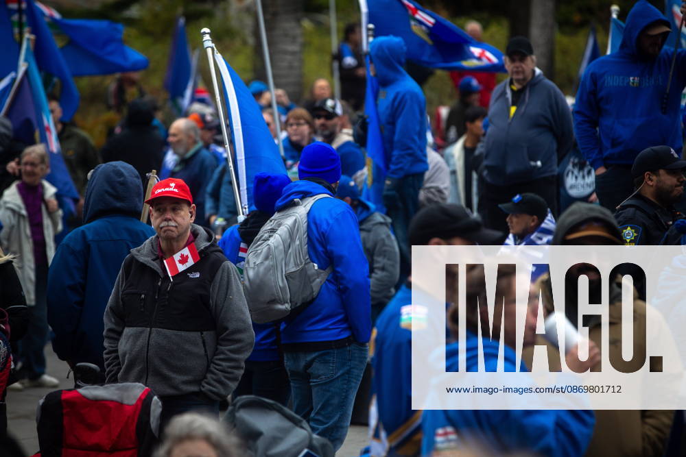 An attendee with a Canadian flag stands in the crowd during an Alberta independence rally at the Alberta legislature, in Edmonton on Saturday, Oct. 17, 2026. Edmonton Canada - ZUMAc35_ 20261017_zaf_c35_078
