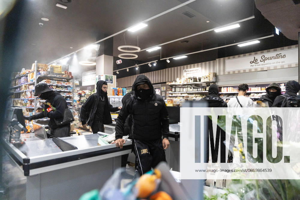 IPA89867722 - Milan, October 18, 2026: More Clashes and Looting in Downtown Milan in the Wake of the Protest; Pictured: Via Torino Rioters Storm the Carrefour Store