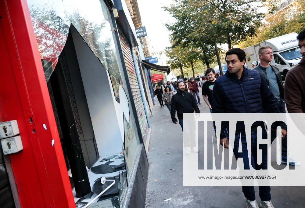 (261018) -- PARIS, Oct. 18, 2026 -- People walk past a shop damaged during a protest in Paris, France, Oct. 18, 2026. French President Emmanuel Macron on Sunday vowed legal action against those responsible for violence during protests across the country on Saturday. ) FRANCE-PARIS-PROTEST-VIOLENCE WuxHuiwo