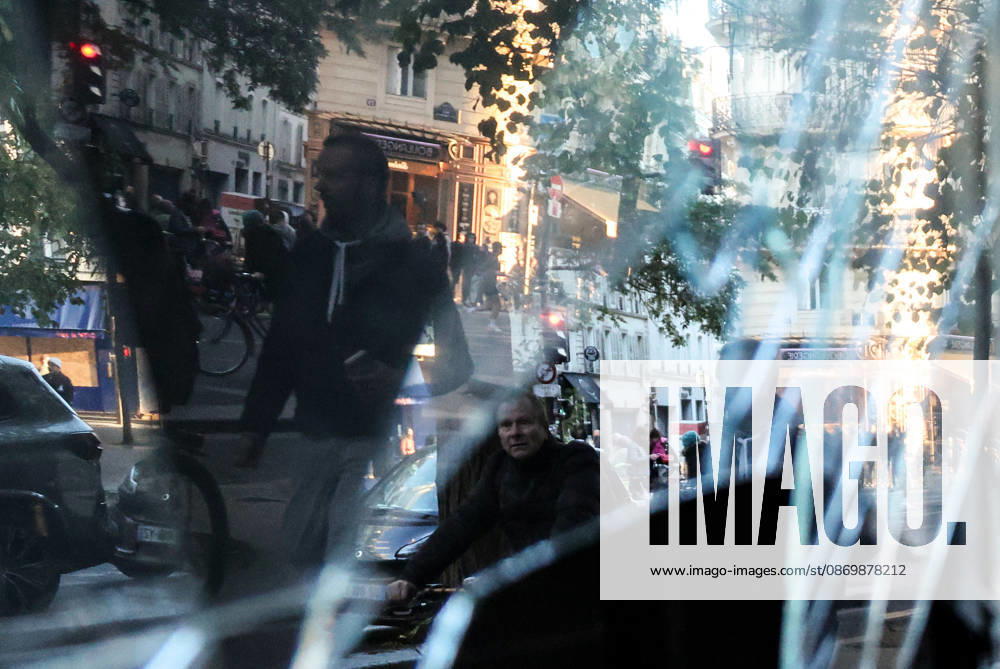 (261018) -- PARIS, Oct. 18, 2026 -- People walk past a shop damaged during a protest in Paris, France, Oct. 18, 2026. French President Emmanuel Macron on Sunday vowed legal action against those responsible for violence during protests across the country on Saturday. ) FRANCE-PARIS-PROTEST-VIOLENCE WuxHuiwo