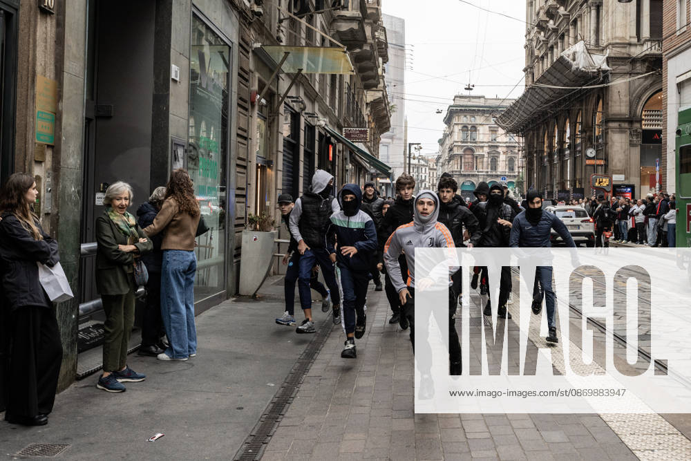 Police detain 160 as unrest continues for second day in Milan MILAN, ITALY - OCTOBER 18: Young protesters flee from police as they run through the streets, damaging shops and public property during urban unrest in Milan, Italy, on October 18, 2026, a day after protests against the rising cost of living. Groups threw stones, bottles, firecrackers and barriers at officers, who responded with tear gas and water cannon. Shops were damaged and looted around the city center, while a Carabinieri vehicle was destroyed. Andrea Carrubba Anadolu Milan Italy. Editorial use only. Please get in touch for any other usage.