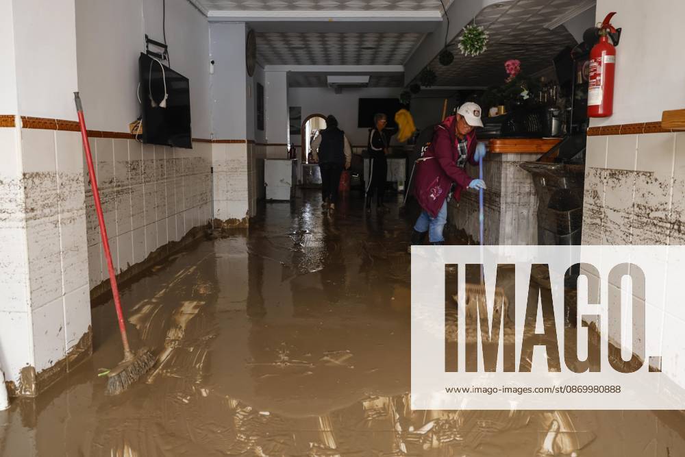The Valencian Regional Government is preparing a lockdown order for the southern coast of Valencia and the northern coast of Alicante due to the rains. Several people are clearing mud from the streets while furniture they had to remove due to flooding caused by the heavy rains piles up, on October 19, 2026, in Els Poblets, Valencian Community, Spain. The Valencian Regional Government is preparing a lockdown order for the southern coast of Valencia and the northern coast of Alicante in response to the emergency declared due to the rains brought by Storm Adam, as announced by the Regional Minister of Emergencies and the Interior early this morning, October 19, from the Emergency Coordination Center (CCE) October 19, 2026, Valencia, Valencian