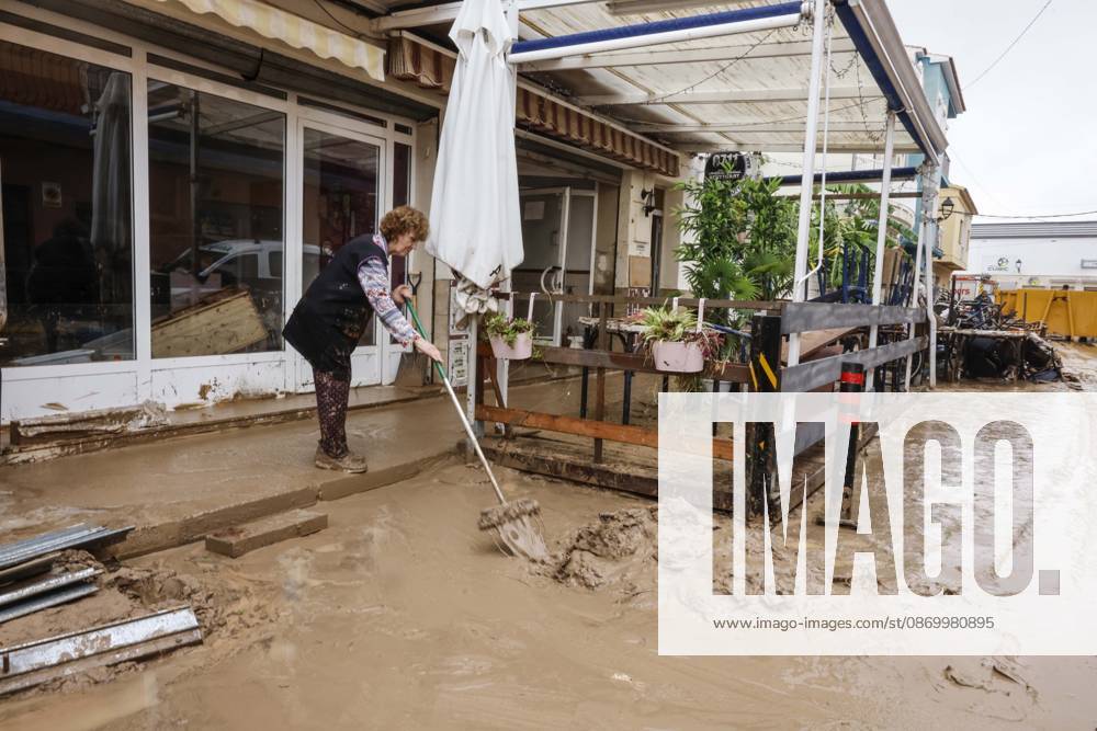 The Valencian Regional Government is preparing a lockdown order for the southern coast of Valencia and the northern coast of Alicante due to the rains. Several people are clearing mud from the streets while furniture they had to remove due to flooding caused by the heavy rains piles up, on October 19, 2026, in Els Poblets, Valencian Community, Spain. The Valencian Regional Government is preparing a lockdown order for the southern coast of Valencia and the northern coast of Alicante in response to the emergency declared due to the rains brought by Storm Adam, as announced by the Regional Minister of Emergencies and the Interior early this morning, October 19, from the Emergency Coordination Center (CCE) October 19, 2026, Valencia, Valencian