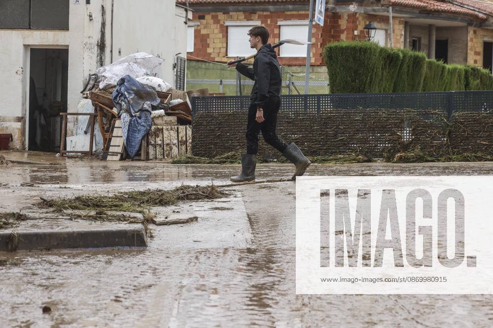 The Valencian Regional Government is preparing a lockdown order for the southern coast of Valencia and the northern coast of Alicante due to the rains. Several people are clearing mud from the streets while furniture they had to remove due to flooding caused by the heavy rains piles up, on October 19, 2026, in Els Poblets, Valencian Community, Spain. The Valencian Regional Government is preparing a lockdown order for the southern coast of Valencia and the northern coast of Alicante in response to the emergency declared due to the rains brought by Storm Adam, as announced by the Regional Minister of Emergencies and the Interior early this morning, October 19, from the Emergency Coordination Center (CCE) October 19, 2026, Valencia, Valencian