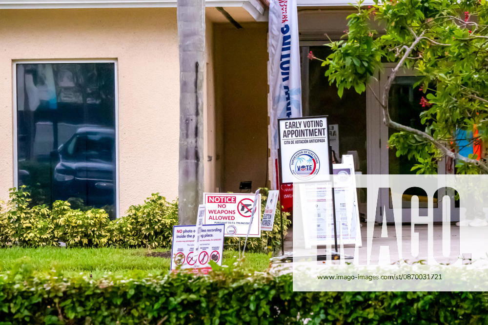 Official election notices, including an Early Voting Appointment sign from Palm Beach County Supervisor of Elections a Notice: No Weapons Allowed sign, and a No photo or video recording inside the polling place warning, stand outside an early voting site in Delray Beach, Florida, on October 19, 2026. The signage outlines polling place policies and regulations as early voting kicks off across Palm Beach County for upcoming local, state, and federal elections. U.S. - ZUMAc343 20261019_znp_c343_006