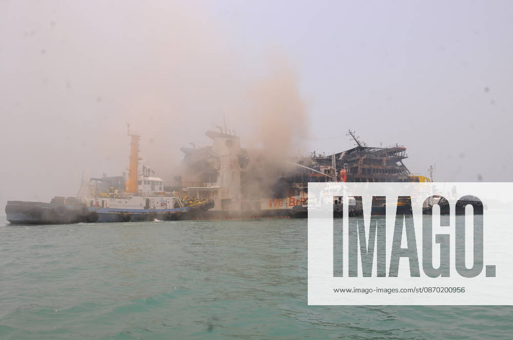 Efforts are underway to extinguish a fire that broke out on a passenger ferry in Indonesia s Cilegon PELABUHAN MERAK, CILEGON, INDONESIA - OCTOBER 21: Fireboats take turns spraying water onto the passenger ferry KMP Batumandi to cool down the vessel after it caught fire while preparing to dock off Merak Port in Cilegon, Banten, Indonesia on Wednesday, October 21, 2026. The vessel caught fire on Tuesday, October 20, and rescue operations remain underway as the ship continues to emit smoke. Water is continuously sprayed to cool the vehicle deck containing numerous cars, motorcycles, buses, and trucks, while authorities confirm no fatalities have been reported. Dasril Roszandi Anadolu Pelabuhan Merak Indonesia. Editorial use only. Please get
